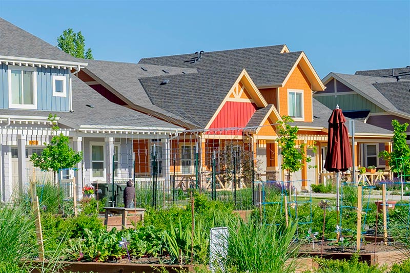 Colorful exterior views of cottages in a garden setting
