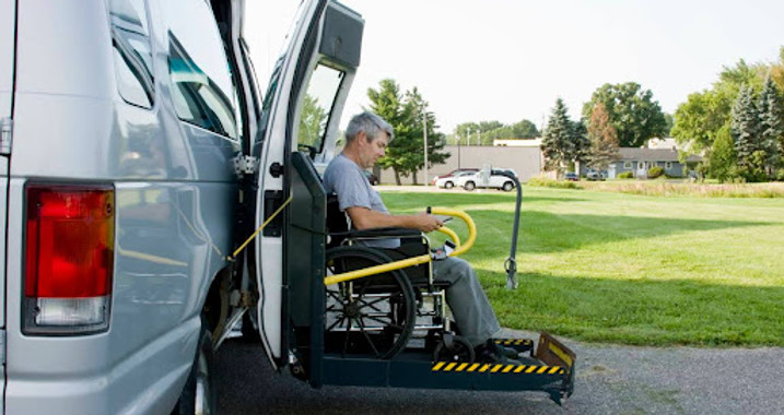 Resident in a wheelchair using a vehicle lift.