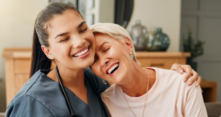 Happy caregiver and resident sharing a moment together.