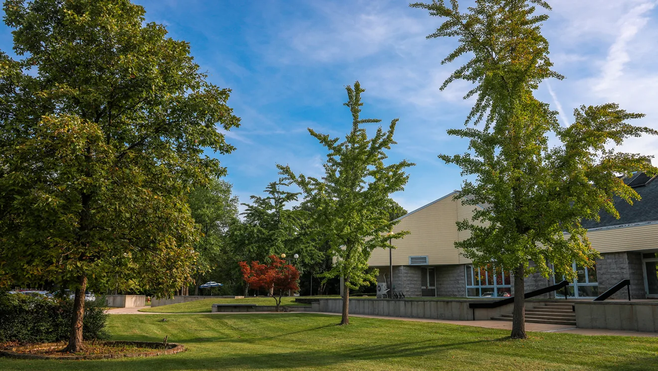 Exterior view of a senior care facility with trees.