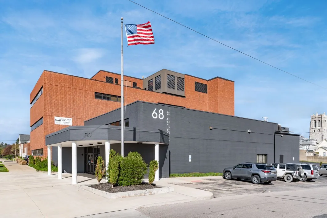 Exterior view of a facility building with American flag