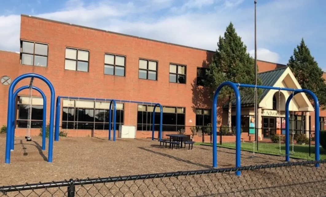 Outdoor play area with swings near the facility