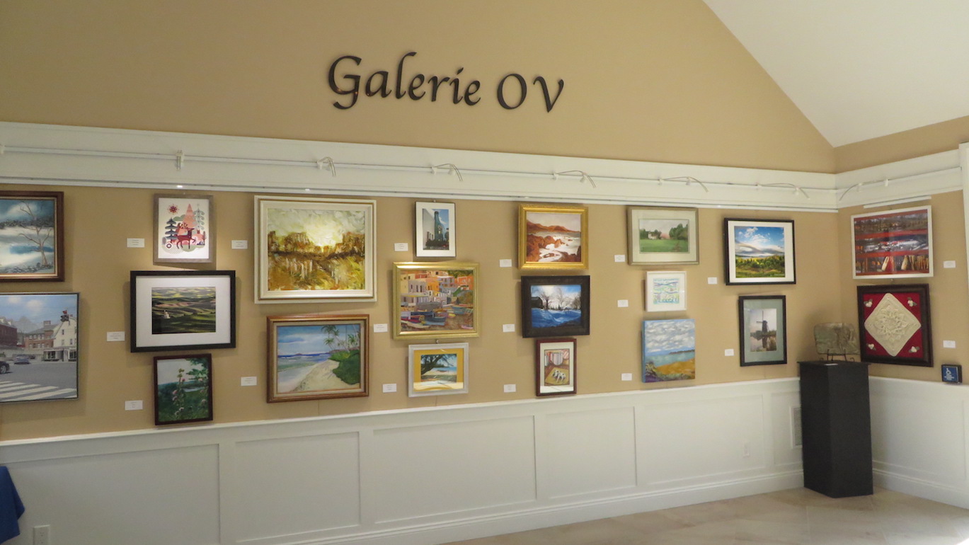 Gallery of framed art pieces on display