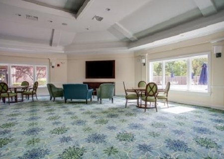 A common area with seating and patterned carpet.