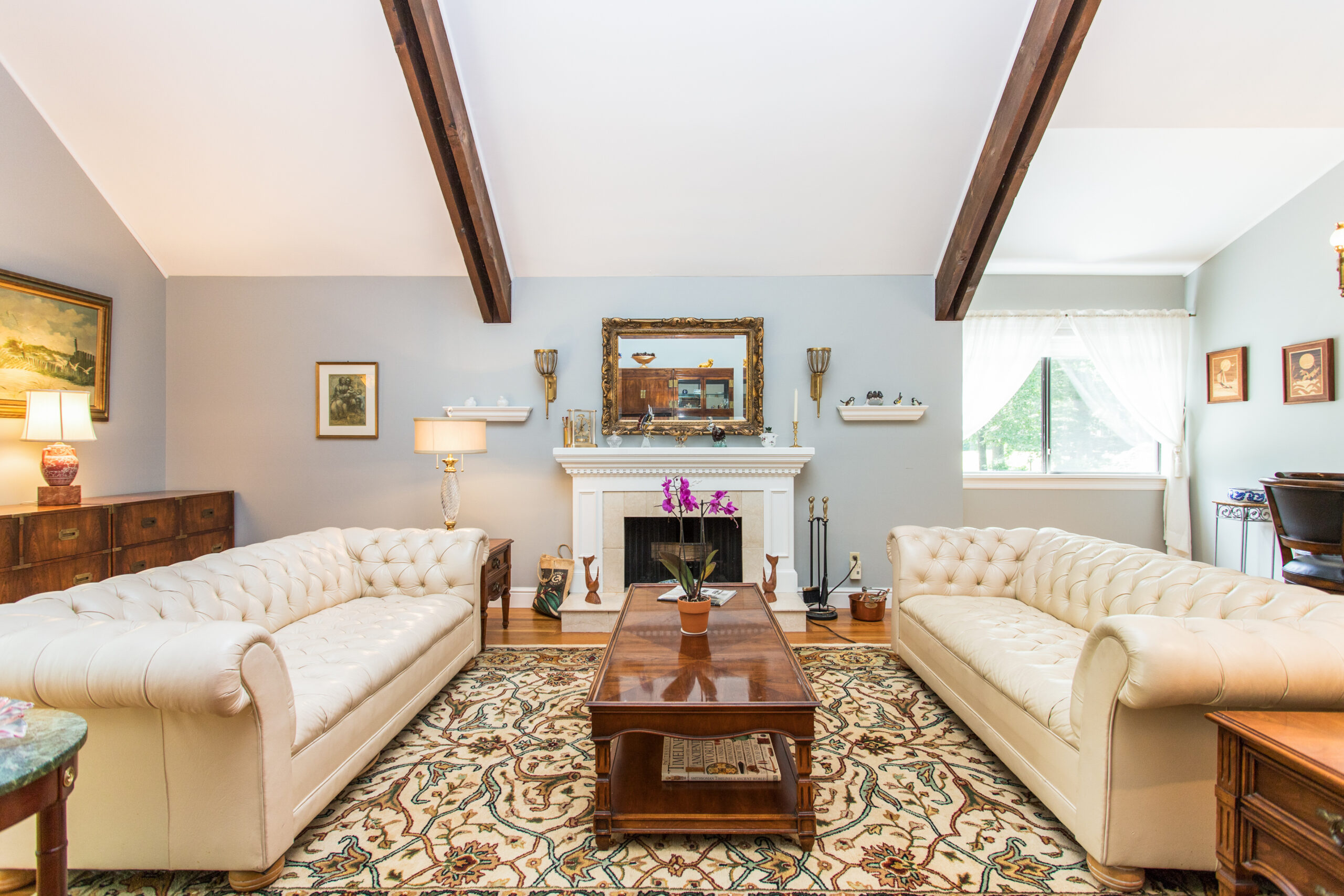 Cozy common area with two sofas and a fireplace.