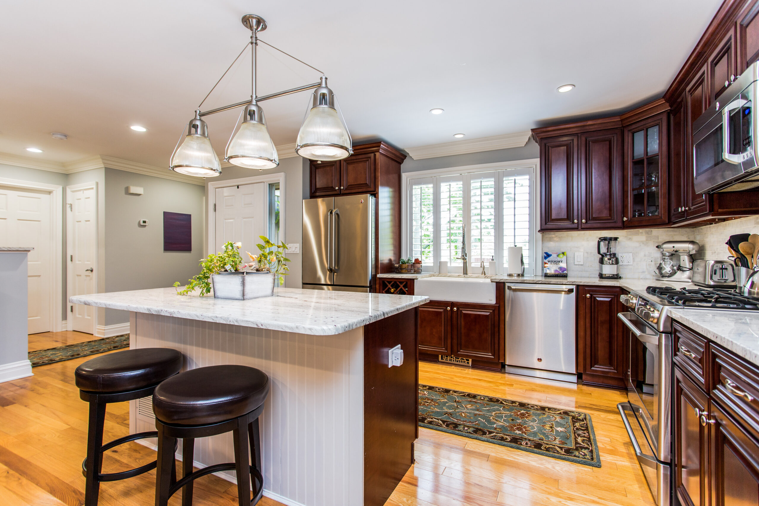Modern kitchen with island seating and cabinetry.