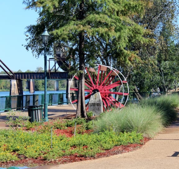 Outdoor area with greenery and a decorative wheel