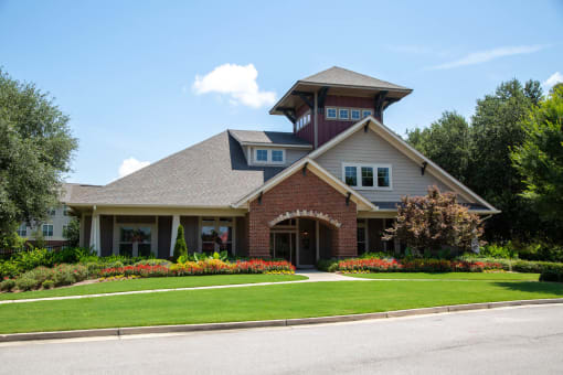 Exterior view of the facility building surrounded by flowers.