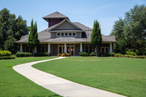Exterior view of the facility with landscaping and path