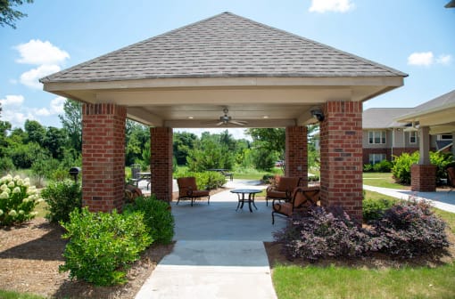 Covered outdoor seating area with landscaping