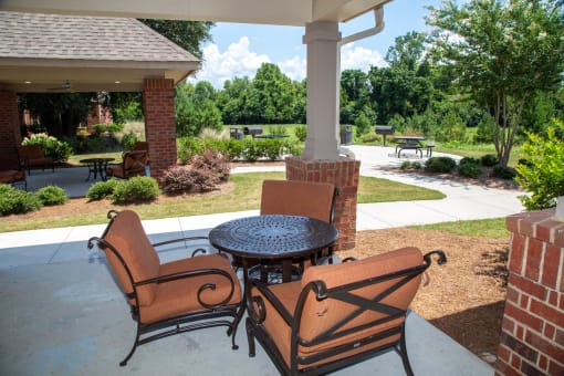 Seating area in outdoor space with garden views.