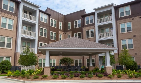 Exterior view of assisted living facility with outdoor seating.