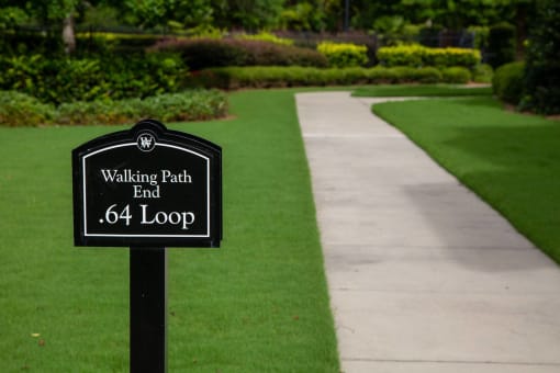 Walking path sign in a landscaped garden