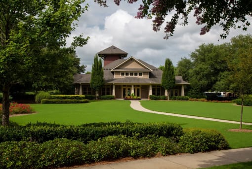 Exterior view of a senior living facility surrounded by landscaping.