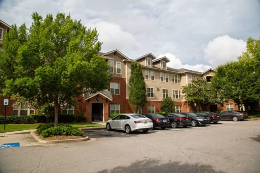 Exterior view of a senior living facility with parking.
