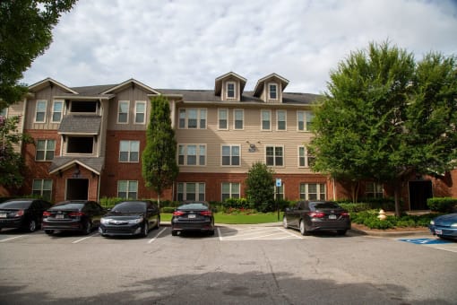 Exterior view of a senior living facility with parking.