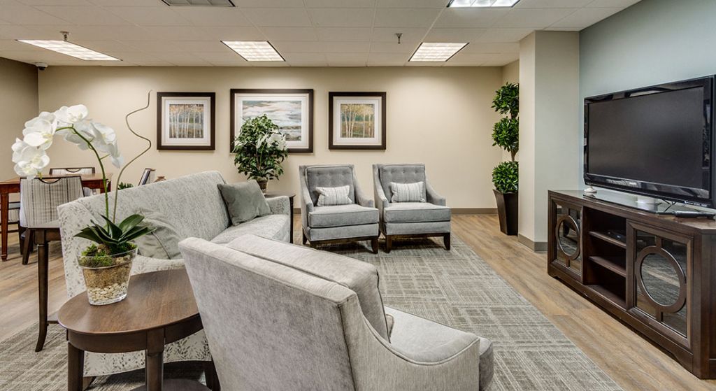 Modern lounge area with comfortable seating and plants.