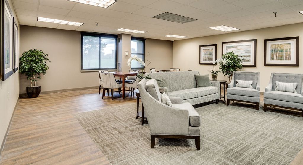 Bright common area with comfortable seating and artwork.