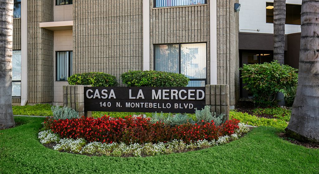 Exterior view of Casa La Merced facility with signage.