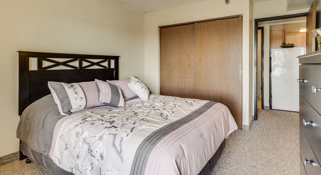 Cozy bedroom with a double bed and dresser