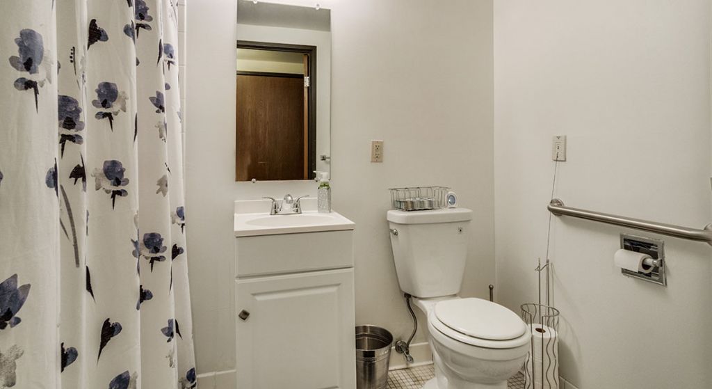 Clean and simple bathroom interior with white decor.