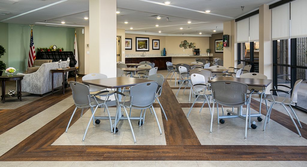 Common area with tables and chairs set up.