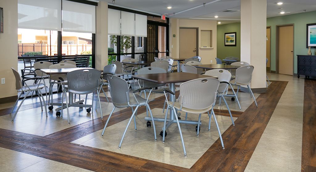 Dining area with tables and chairs arranged for activities.