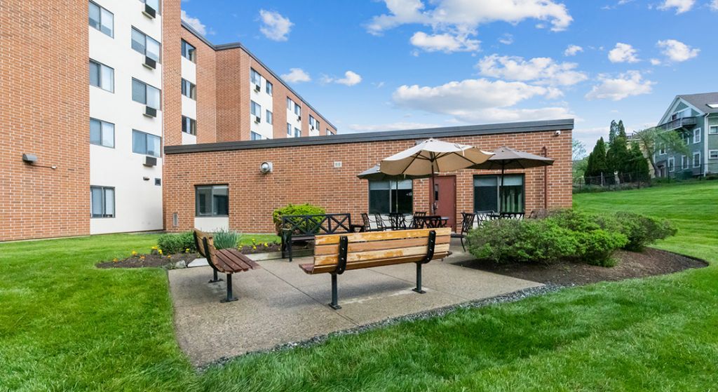 Outdoor seating area with benches and umbrellas