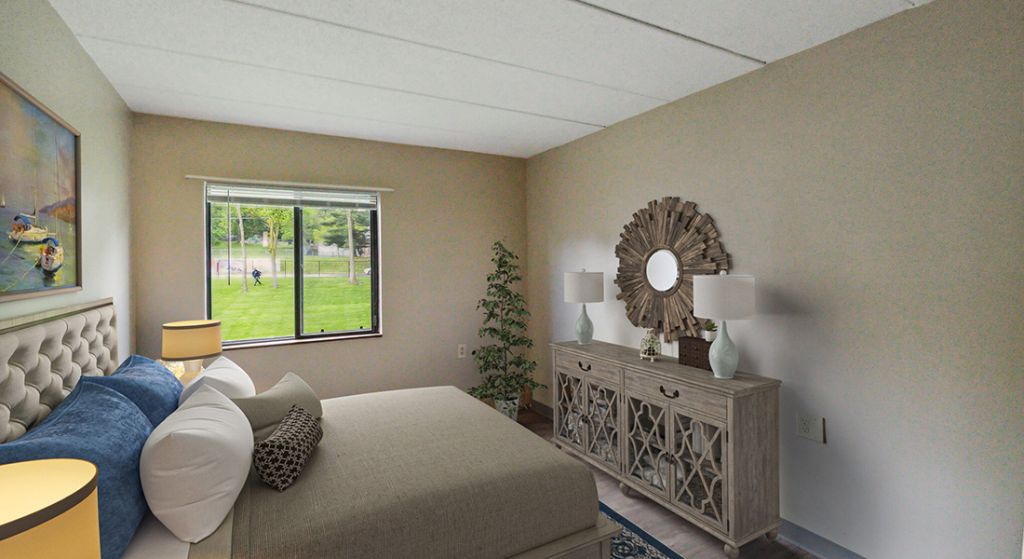 Spacious bedroom with natural light and decor.