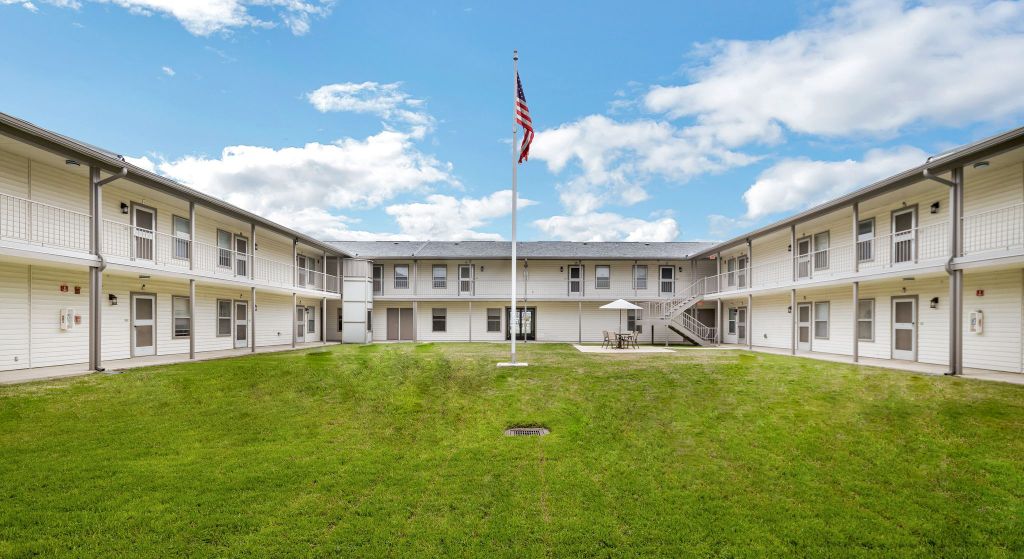 Courtyard area with grass and flagpole