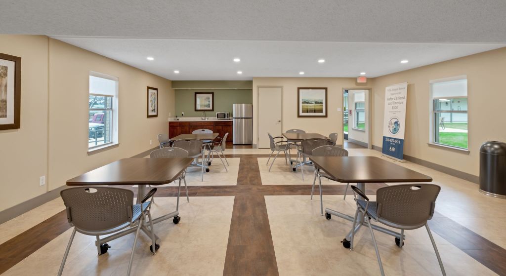Common area with tables and chairs in the facility
