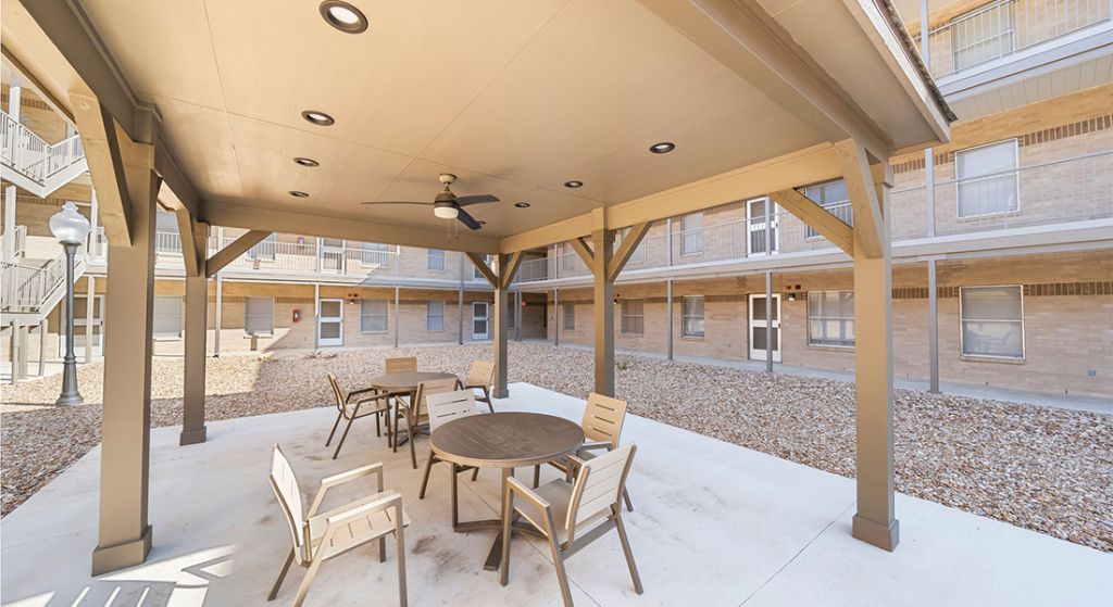 Outdoor seating area with tables and chairs.