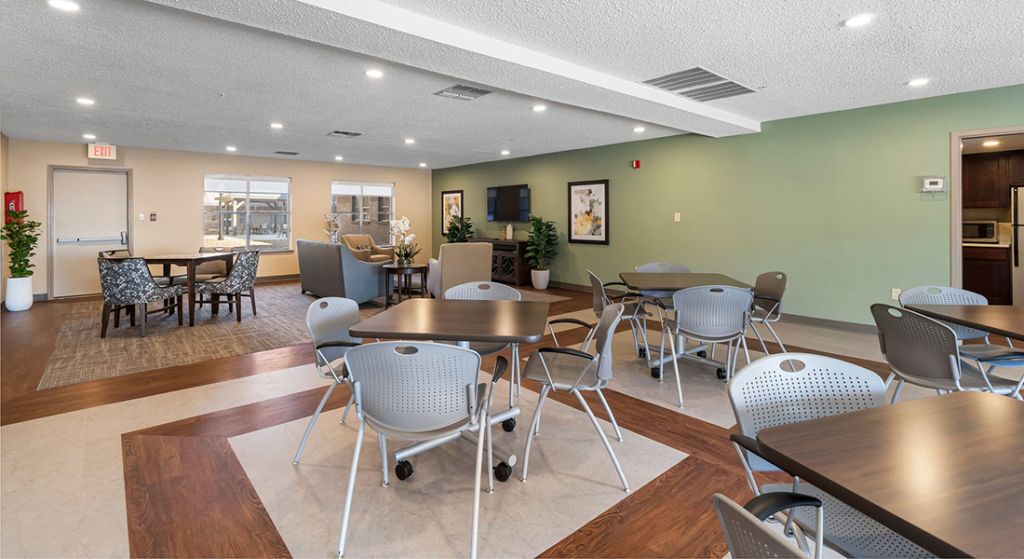 Bright common area with tables and chairs.