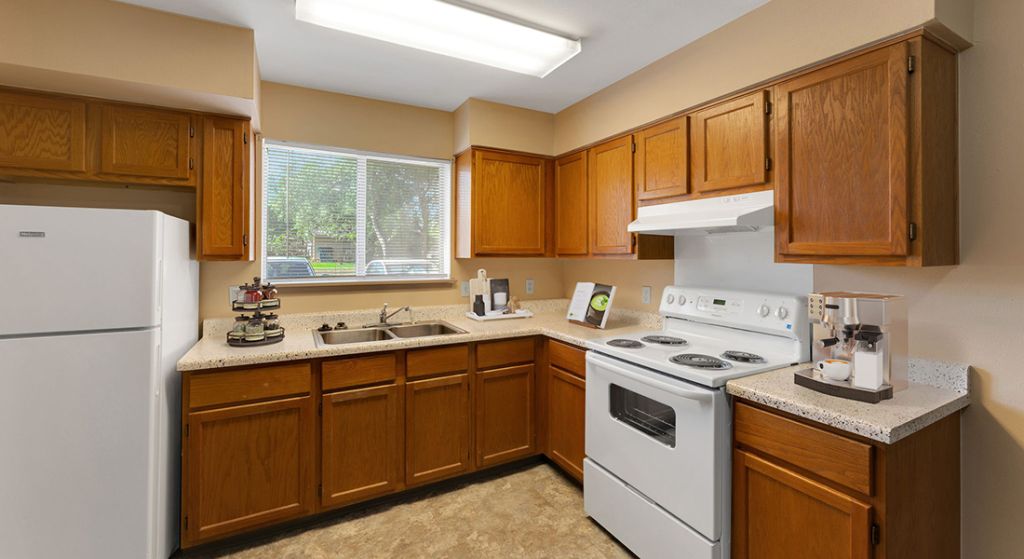 Bright kitchen area with wooden cabinets.