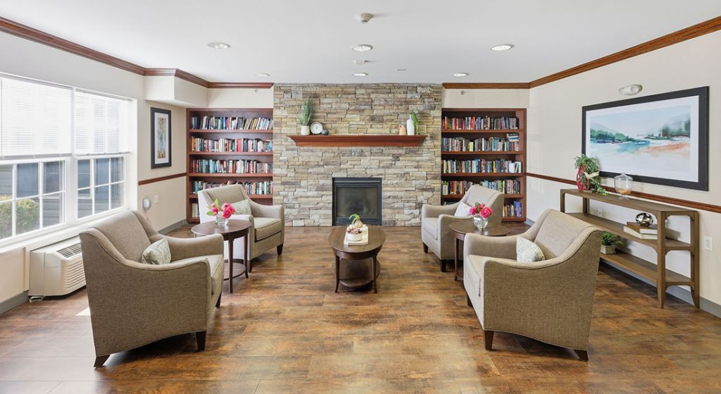 Cozy common area with seating and bookshelves.