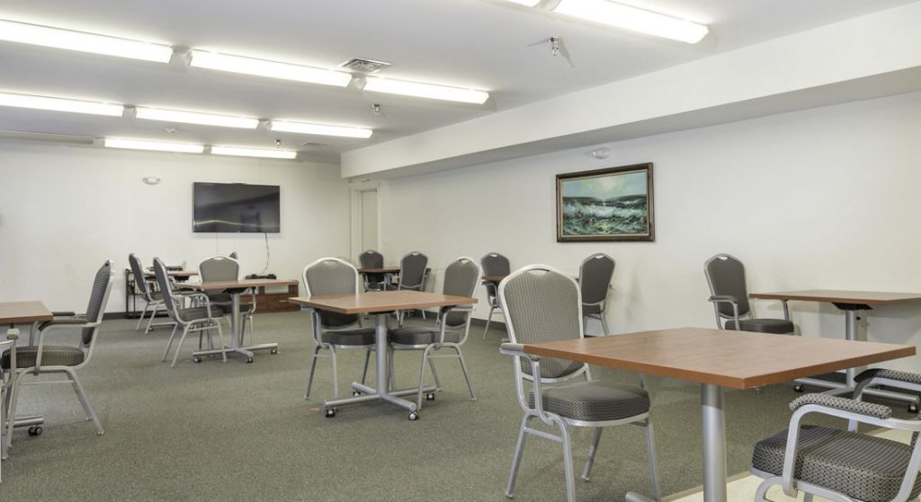 Empty common area with tables and chairs.