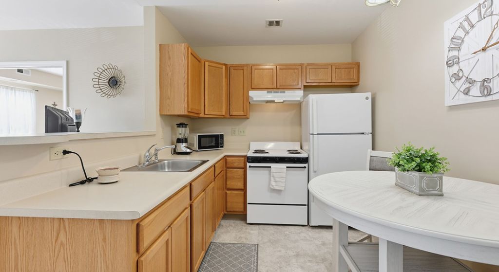 Kitchen area with cabinetry and appliances.