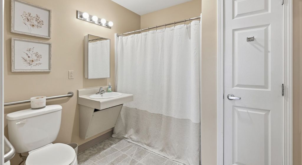 Neat bathroom with a shower, sink, and toilet