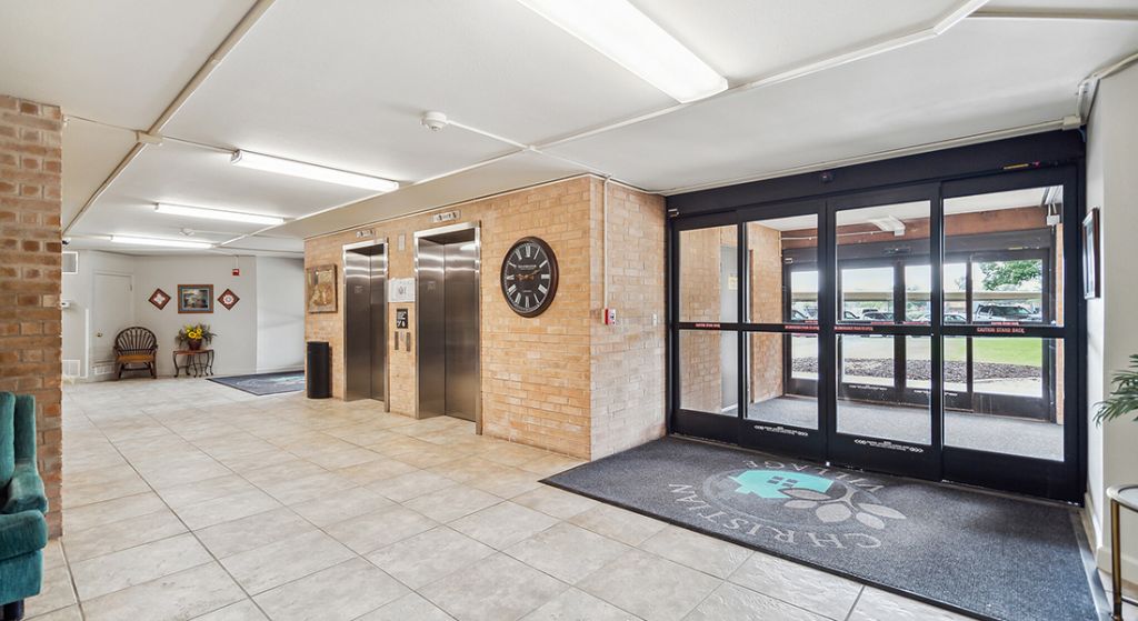 Interior hallway with elevators and seating area