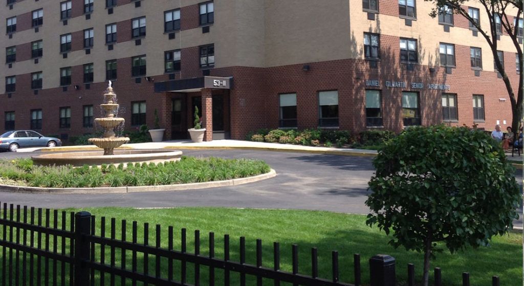 Exterior view of the senior apartments with a fountain.