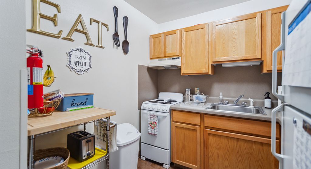Cozy apartment kitchen with cooking supplies.