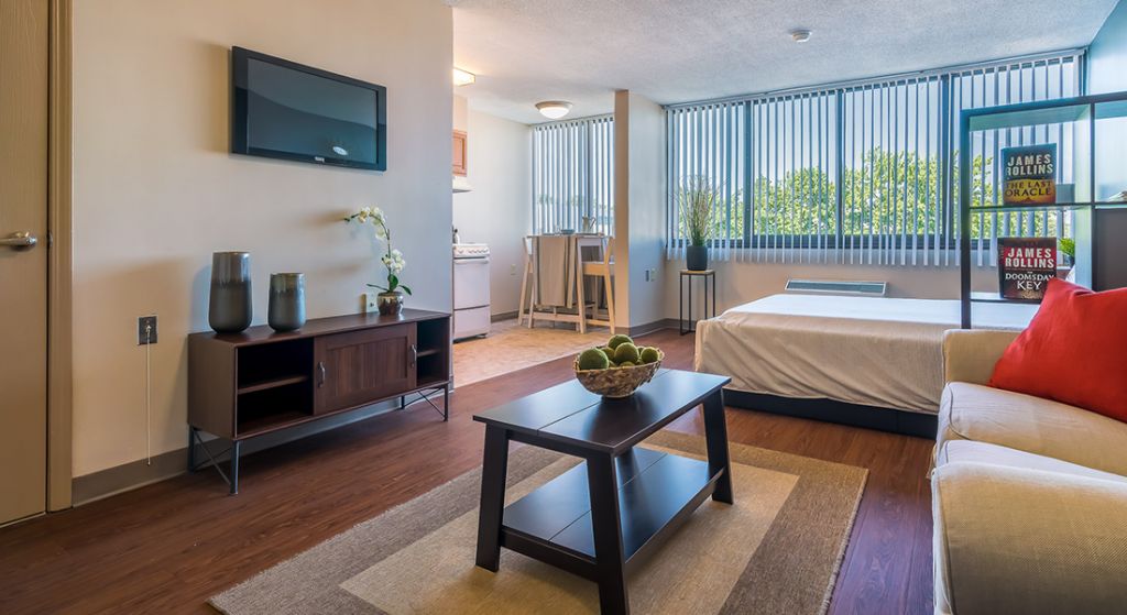 Bright, modern studio apartment with a kitchen area.