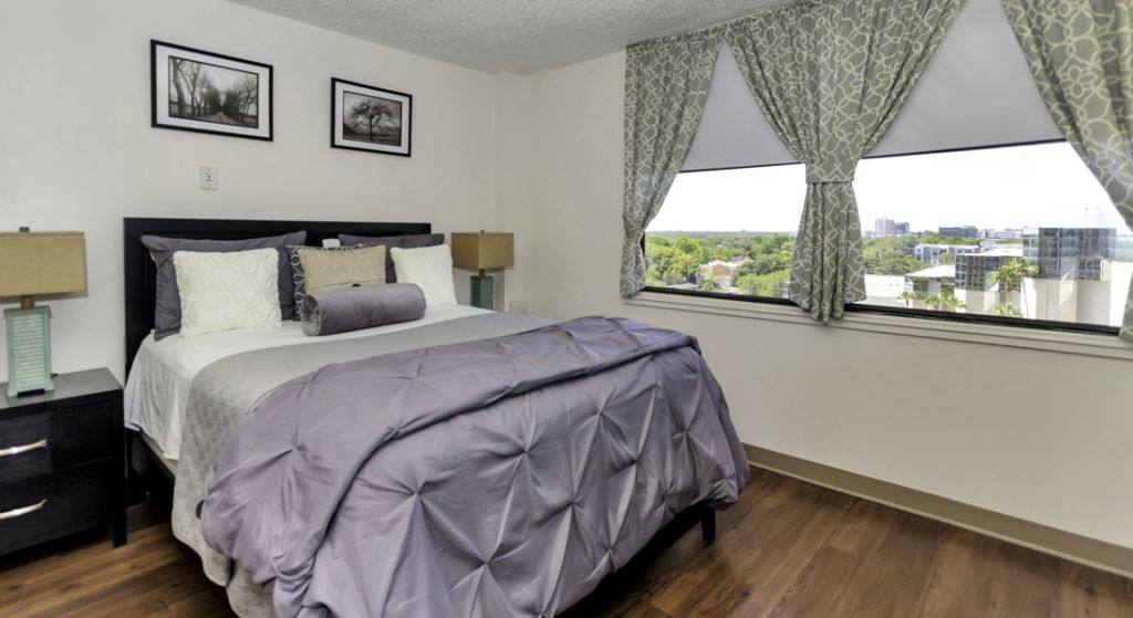 Cozy bedroom with a view in a senior apartment.