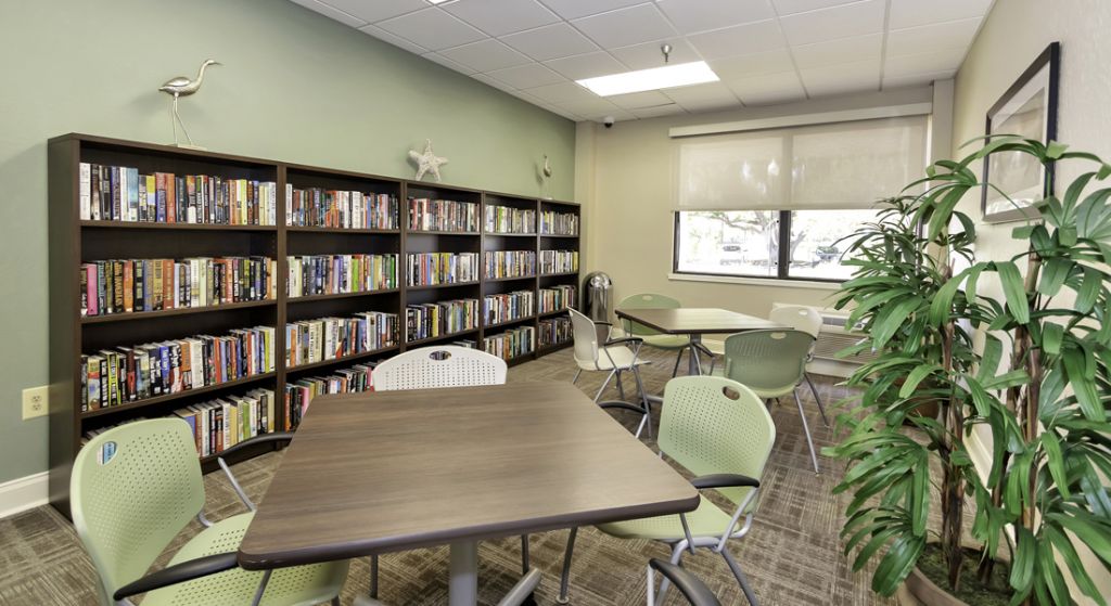 Interior common area with bookshelves and tables.