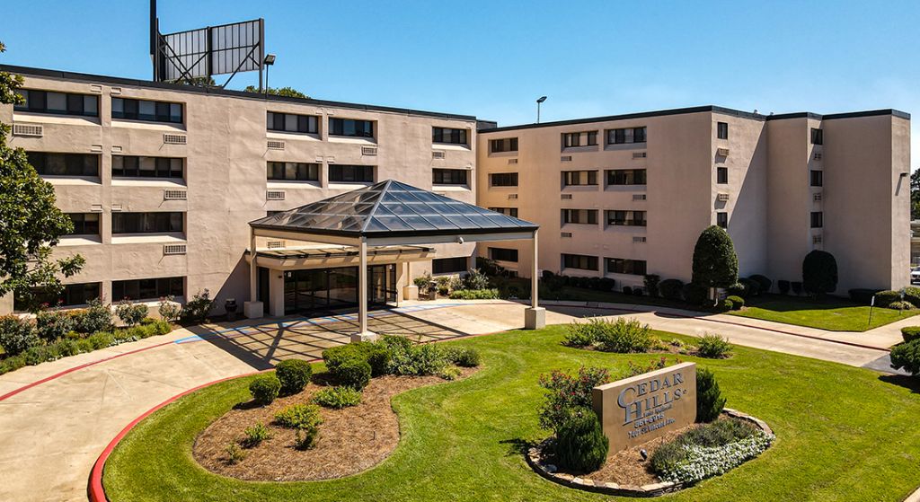 Exterior view of Cedar Hills facility with landscaped grounds.