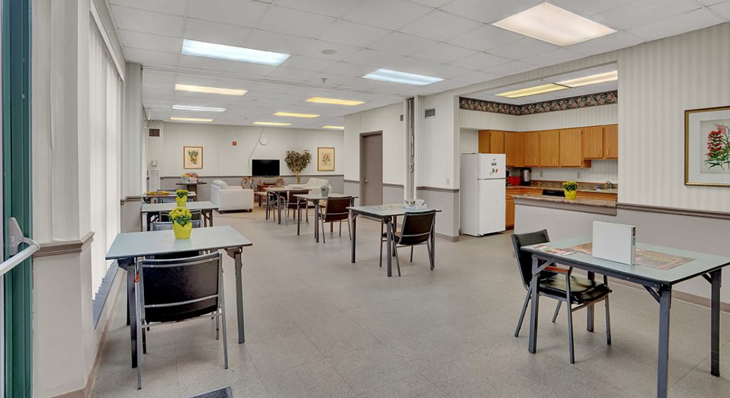 Bright common area with tables and chairs.