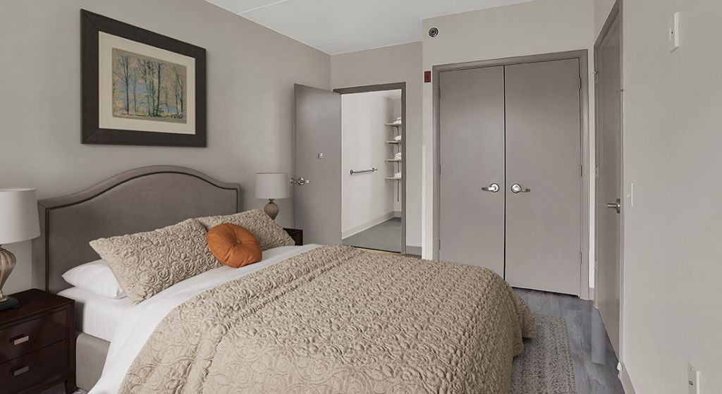 Cozy bedroom with a neatly made bed and decor