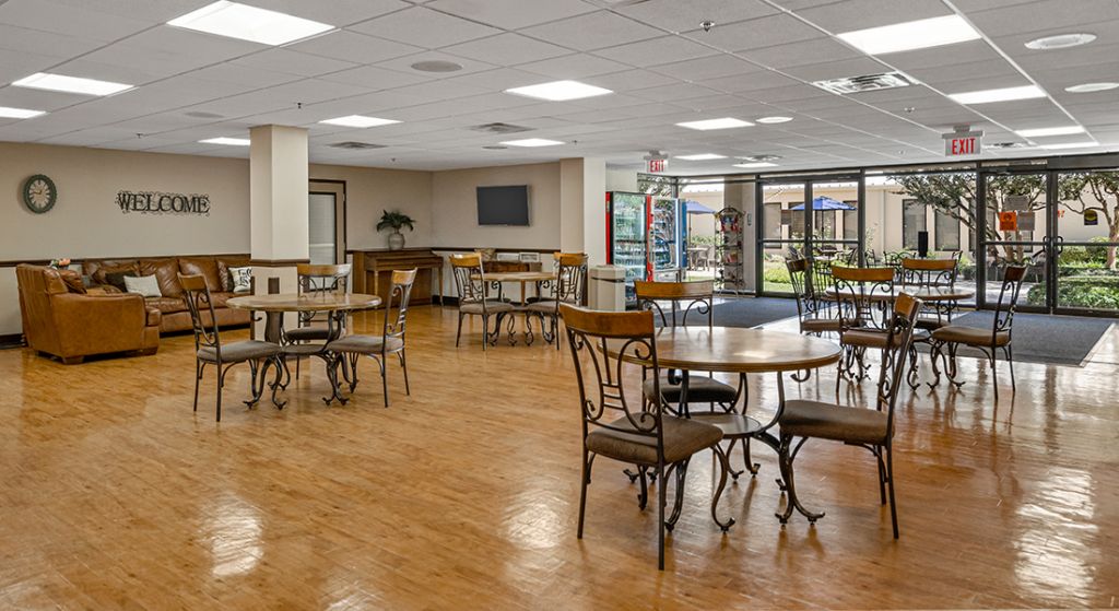 Bright common area with seating and tables