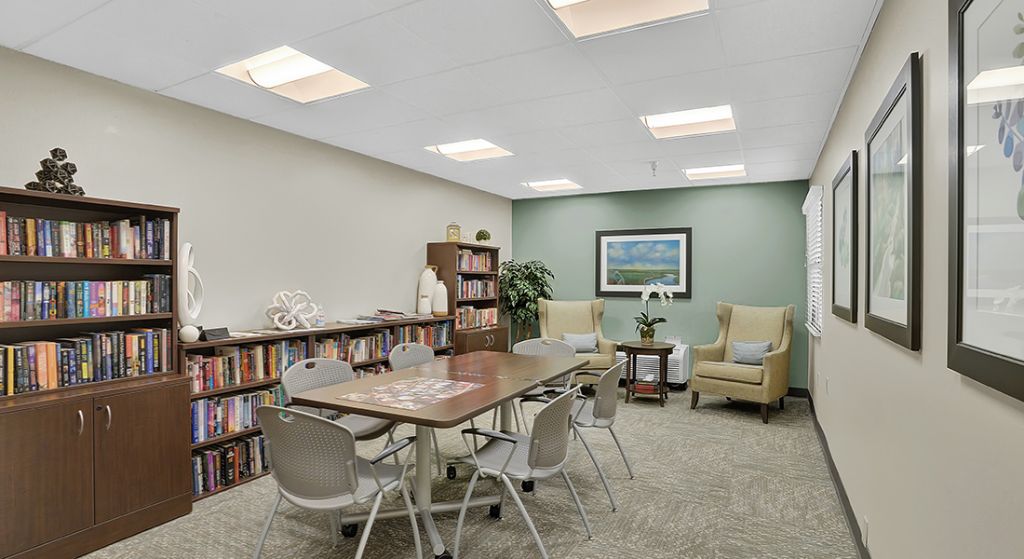 Cozy common area with seating and bookshelves.