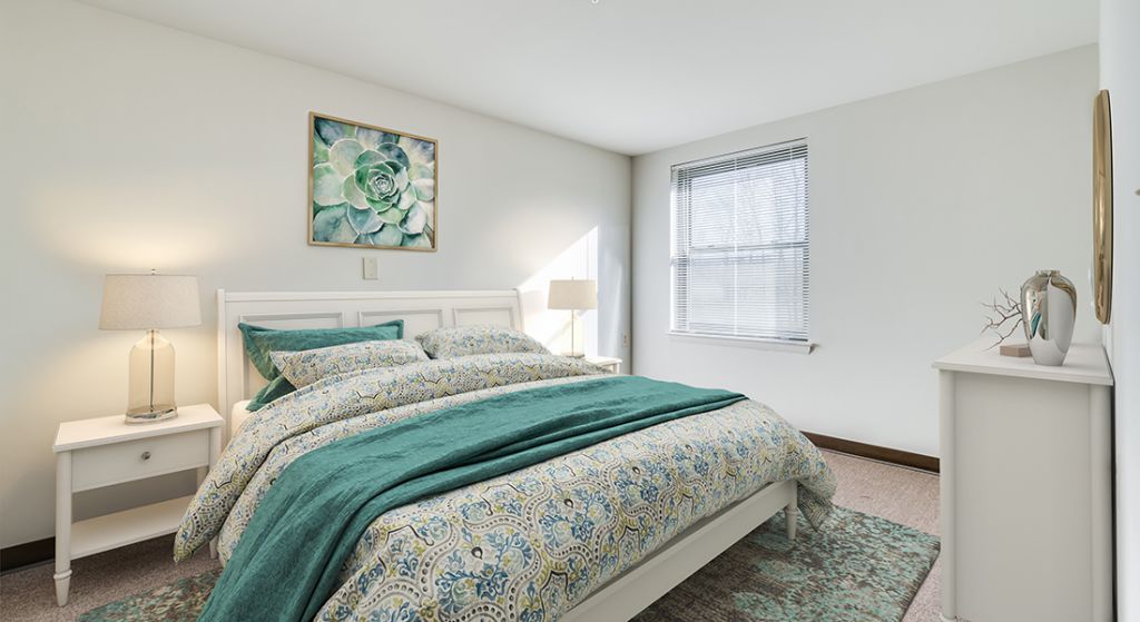 Cozy bedroom with green and blue decor.